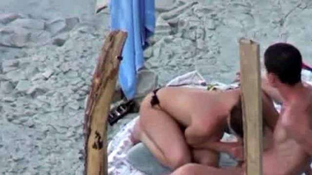 A couple is spying on camera at the beach