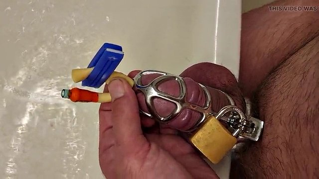 Pissing with a catheter locked in a chastity cage