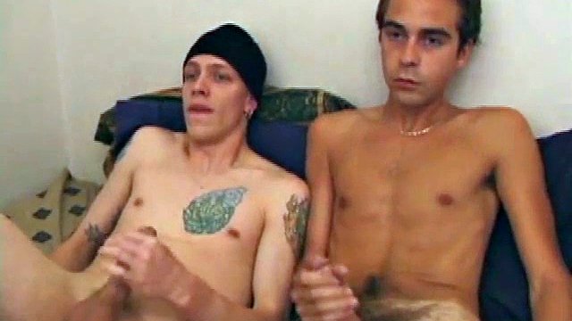 Shane and Vincenzo lay back on the bed with the goal of eventually covering each other's faces in cum. They start watching porn videos and wipe their hard-on through their pants. The clothes get too tight and soon they come off.