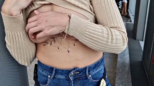 showing off her tits in public at the airport, showing her tits to everyone