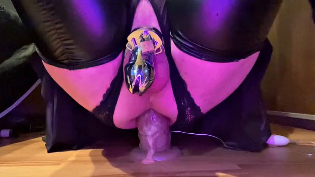 Sissy rides her toy while wearing chastity