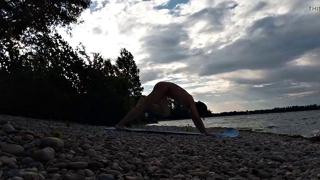Slim nudist boy doing yoga naked on a nudist beach. Nude yoga video by John Artin, gay porn model, skinny naturist, twink, practice