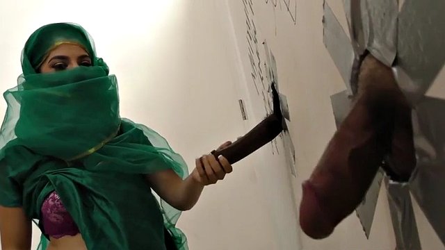 Nadia Ali has fun with a black cock in a glory hole