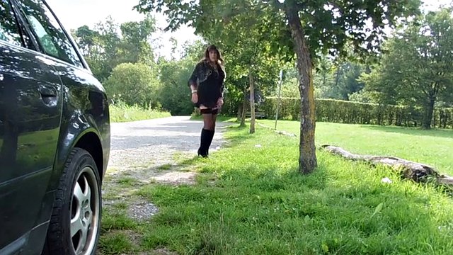 Gay slut in stockings and boots strokes his dick outdoors