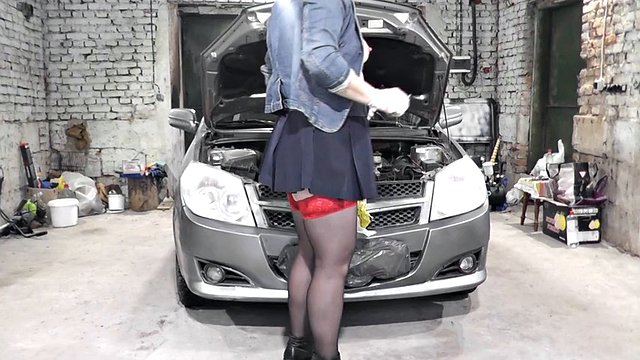 Naked blonde MILF in a car repair shop repairing a client's car. No panties upskirt. No bra. MILF no panties in public
